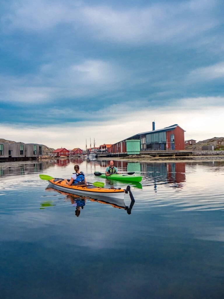 Två personer paddlar kajak utanför Restaurang Vatten i Skärhamn
